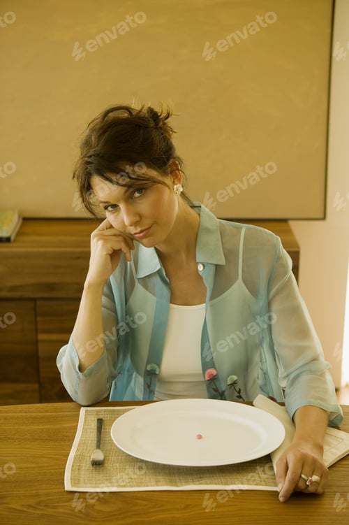 Preview: Woman Depressed Over Amount Of Food On Plate