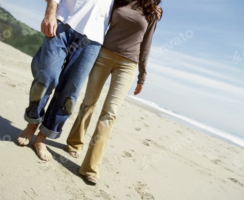 Preview: Tilted View Of A Young Couple Walking On The Beach
