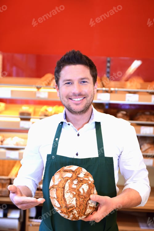 Preview: Sales Assistant Offering Bread In An Organic Grocery Store