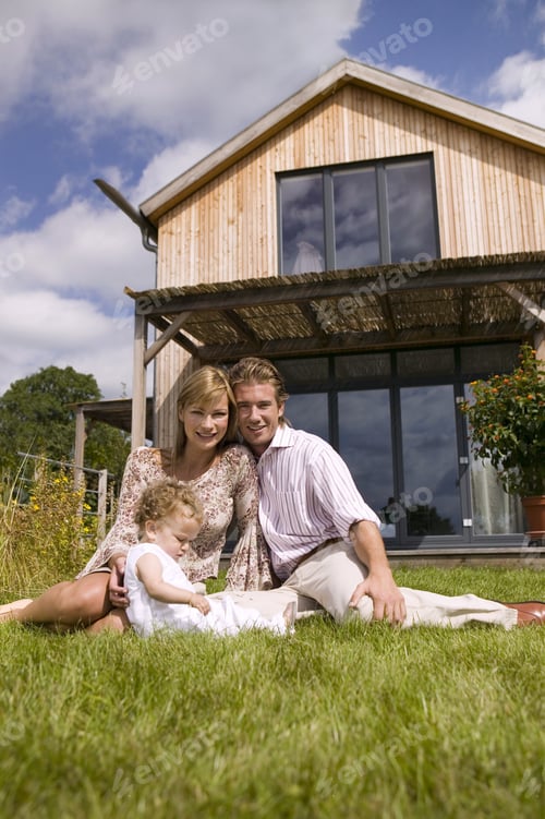 Preview: Young Family Sitting In Front Of House