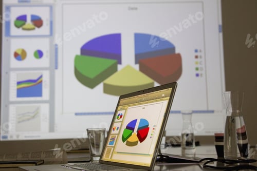 Preview: Laptop displaying charts in a business setting