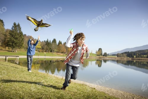 Preview: Father And Son Flying Kite Near Lake