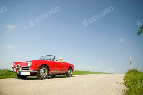 Preview: Woman Driving Convertible In Countryside