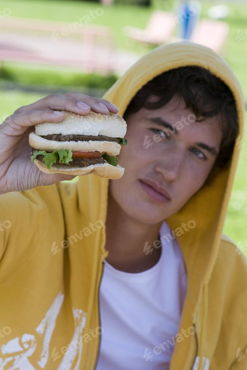 Preview: Teenage Boy Holding Double Hamburger