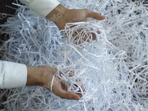 Preview: Businessman Holding Bunch Of Shredded Paper