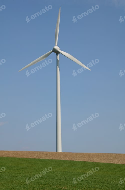 Preview: View Of A Wind Engine Against Blue Sky With Grass In The Foreground