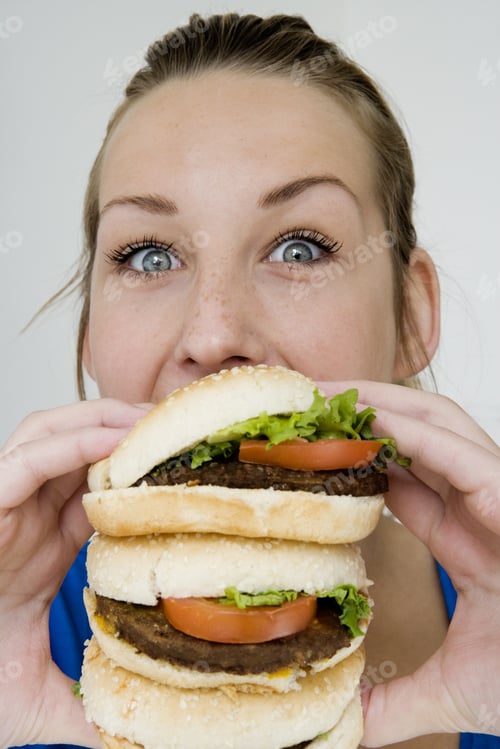 Preview: Teenage Girl Eating A Triple Hamburger