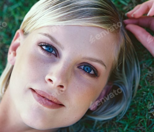 Preview: Close-Up Portrait Of Young Woman Lying In Grass