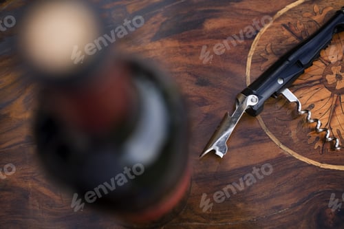 Preview: High Angle View Of Wine Bottle And Corkscrew On Table