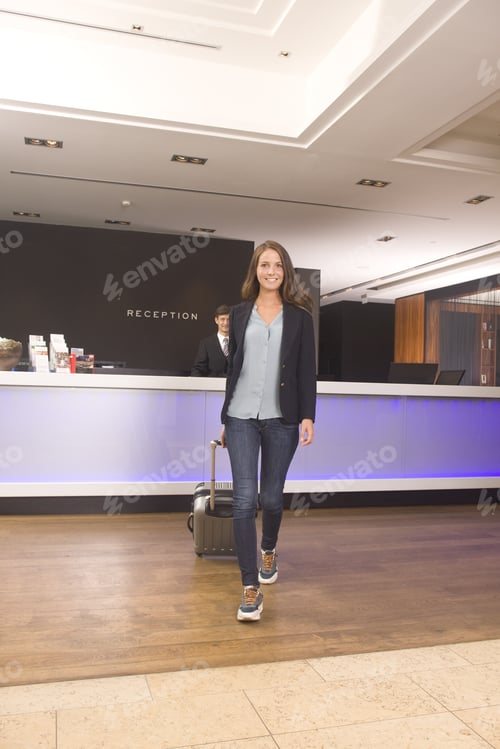Preview: Young Woman Walking Away From Hotel Reception