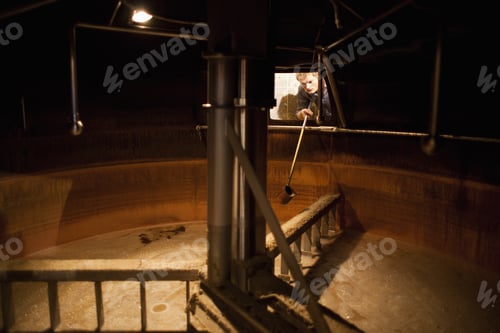 Preview: Brewer Taking A Beer Sample From A Lauter Tun At Brewery In Traunstein, Bavaria, Germany