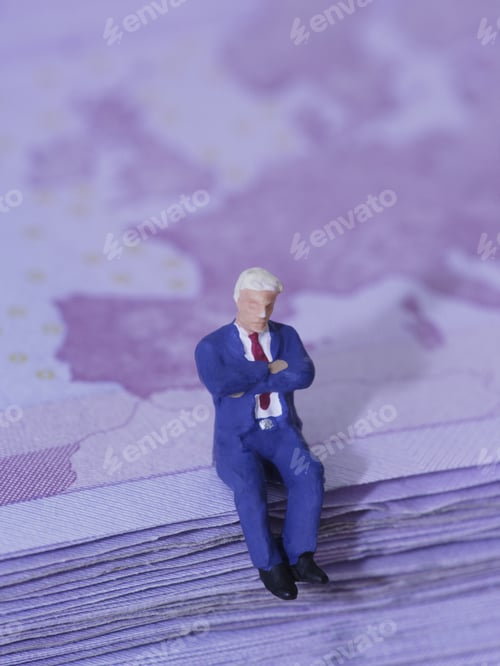 Preview: Figurine Of Businessman Sitting On Stack Of Paper