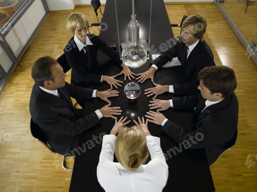 Preview: Businesspeople At Conference Table With Crystal Ball In Center