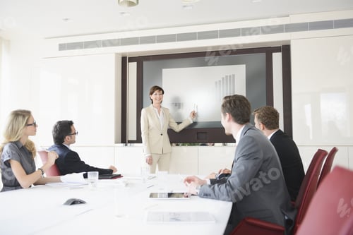 Preview: Businesswoman Giving Presentation In Conference Room