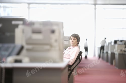 Preview: Businessman Leaning Back In Chair In Cubicle