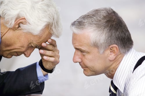 Preview: Businessman Talking To Senior Businessman With Head In Hand