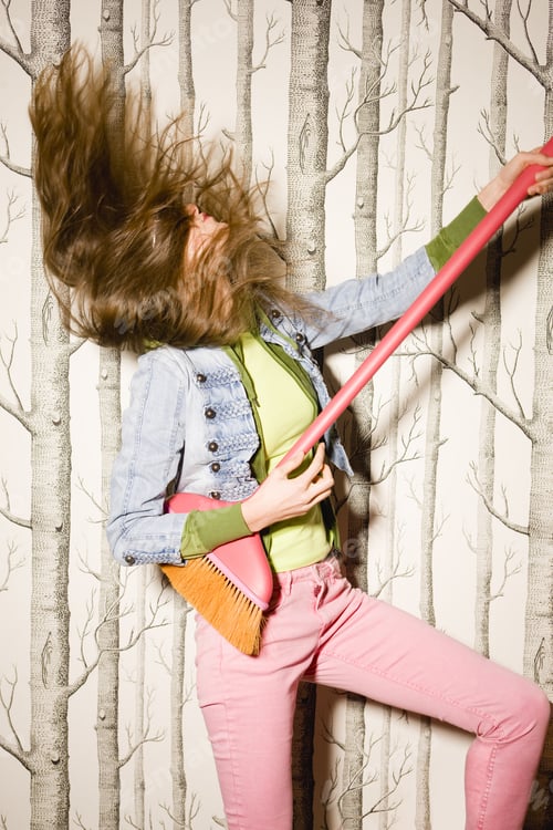 Preview: Portrait Of Young Woman Holding Broom And Head Banging