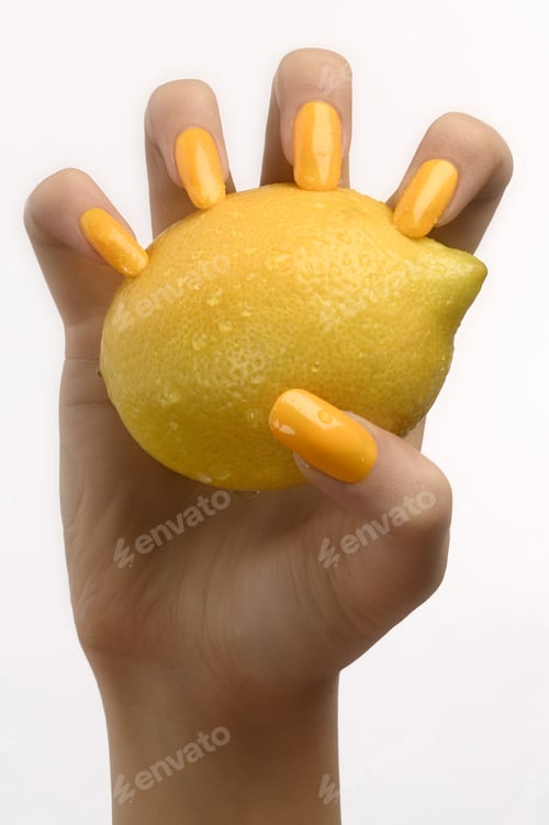 Preview: Studio Shot Of Woman’S Hand With Painted Fingernails Holding Lemon