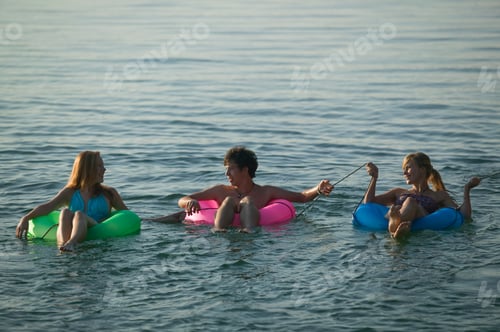Preview: Teenagers In Inner Tubes On Lake