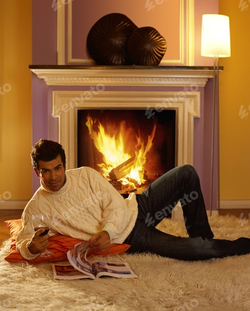 Preview: Man Relaxing by Fire with Wine and Magazine