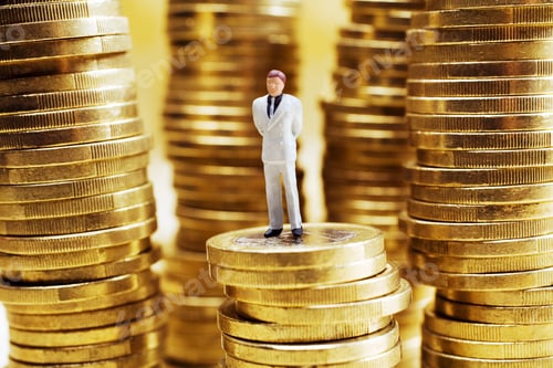 Preview: Businessman Figurine On Stack On Euro Coins