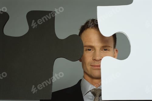 Preview: View Of Businessman Posing Behind Large Puzzle Pieces