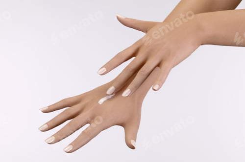 Preview: Studio Shot Of Woman Applying Moisturizer To Hand