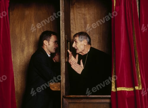 Preview: Businessman In Confessional With Priest