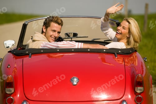 Preview: Couple Driving Convertible In Countryside