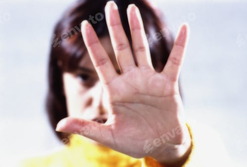 Preview: Portrait Of A Young Woman Blocking View With Hand
