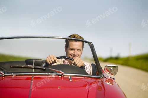 Preview: Man Driving Convertible In Countryside