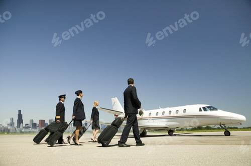 Preview: Flight Crew Wheeling Suitcases To Airplane On Tarmac