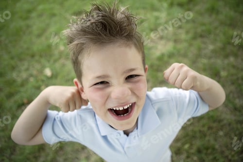 Preview: High Angle View Of Young Boy Smiling Outdoors