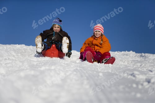 Preview: Boy And Girl Tobogganing In Snow