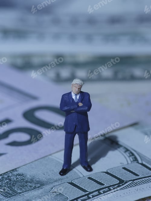 Preview: Figurine Of Businessman Standing On Us Dollars