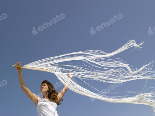 Preview: Woman Holding Fringe Over Head In Wind