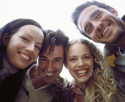 Preview: Low Angle View Of A Group Of Friends In A Huddle Smiling For The Camera