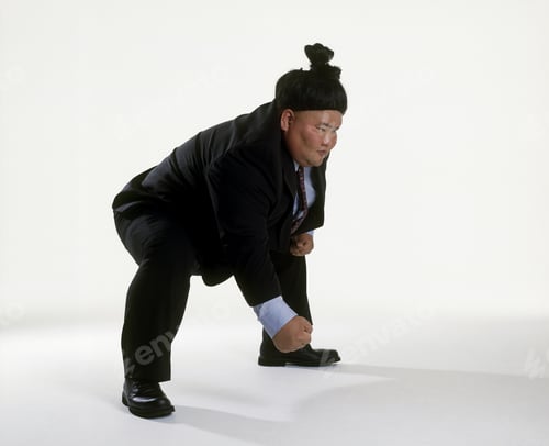 Preview: View Of A Sumo Wrestler In A Business Suit Squatting
