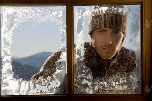 Preview: Man Looking Through Frosty Window