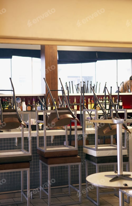 Preview: View Of Stacked Chairs On Tables At A Bar