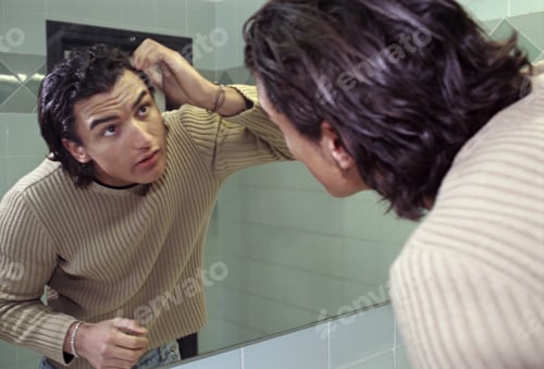 Preview: View Of A Man Looking At Himself In A Mirror