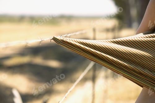 Preview: Detail View Of A Piece Of Fabric Caught On A Barbed Wire Fence