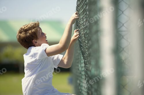 Preview: View Of Young Boy Climbing Chain Link Fence