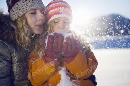 Preview: Mother And Girl Blowing Snow