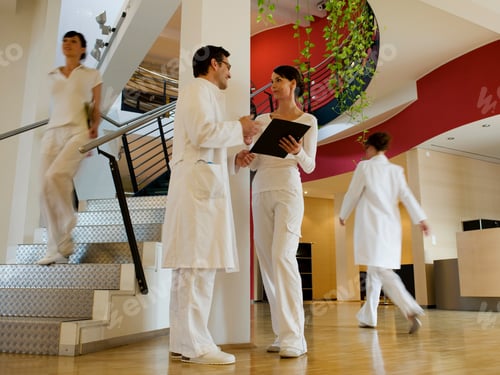 Preview: Doctor Talking To Nurse In Hospital Lobby