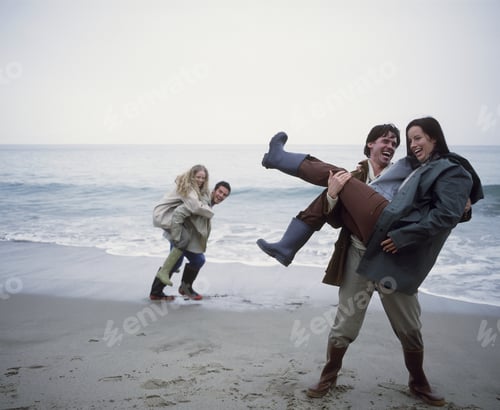 Preview: View Of Two Young Couples On The Beach