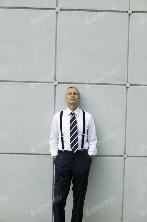Preview: Middle-Aged Businessman Standing Against Wall Without Suit Jacket