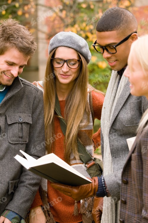 Preview: Young University Friends Reading Textbook On College Campus