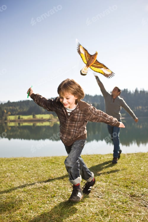 Preview: Father And Son Flying Kite Near Lake