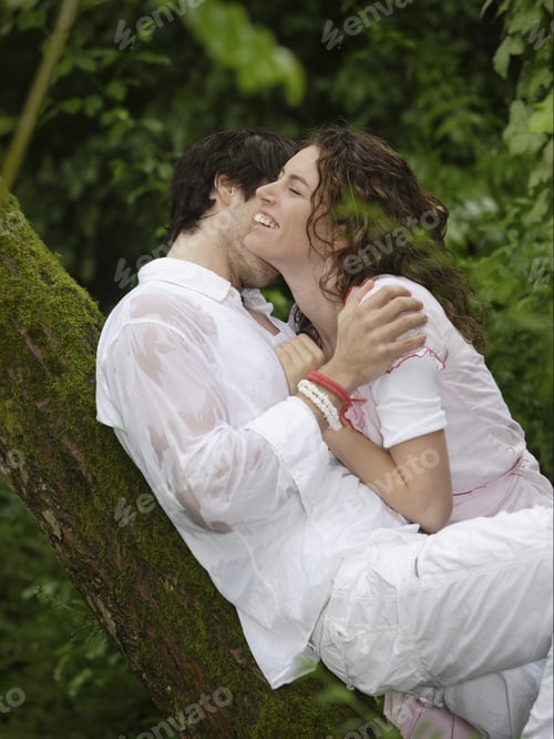 Preview: Couple Leaning On Tree And Hugging